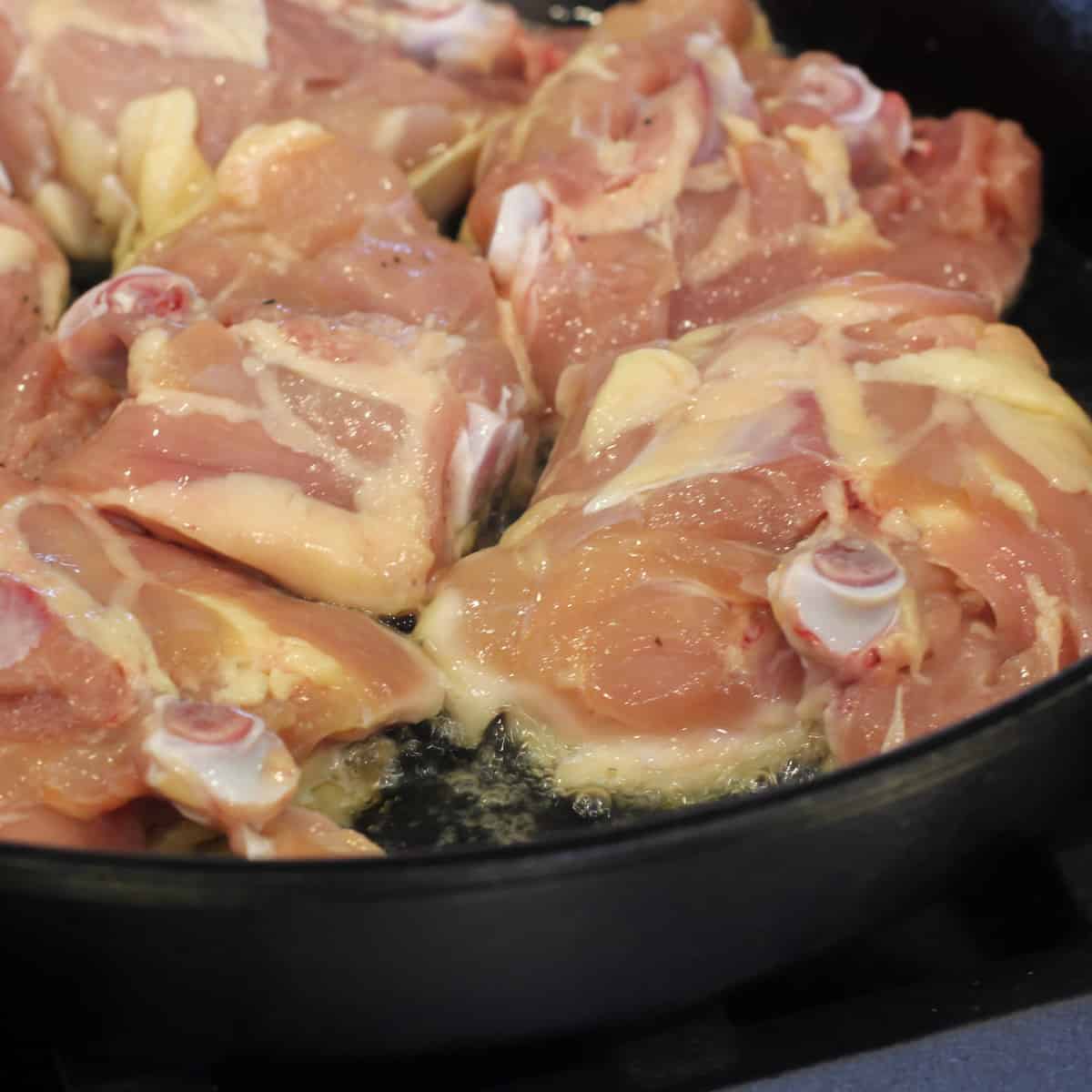 Raw chicken in some hot oil.