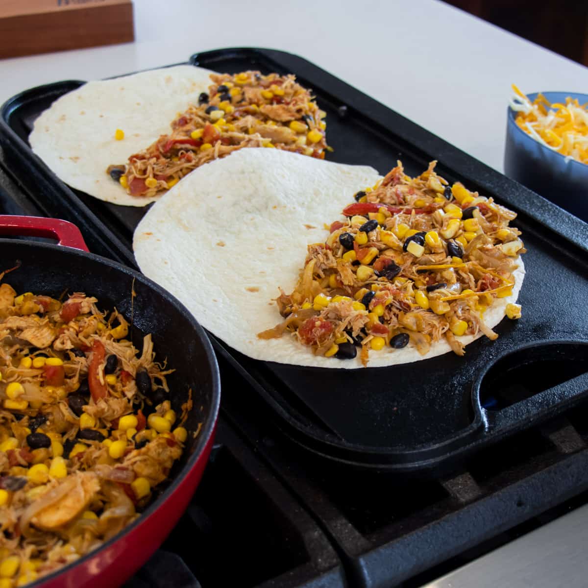 Filling added to half of two soft tortilla shells.