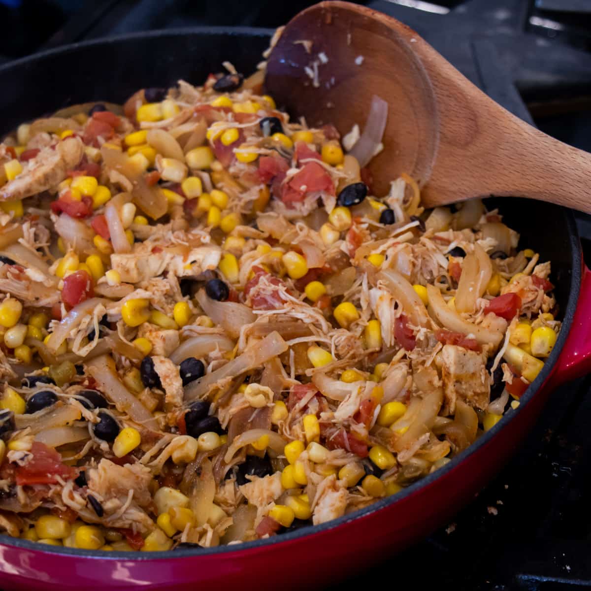 Chicken, corn black beans in a skillet.