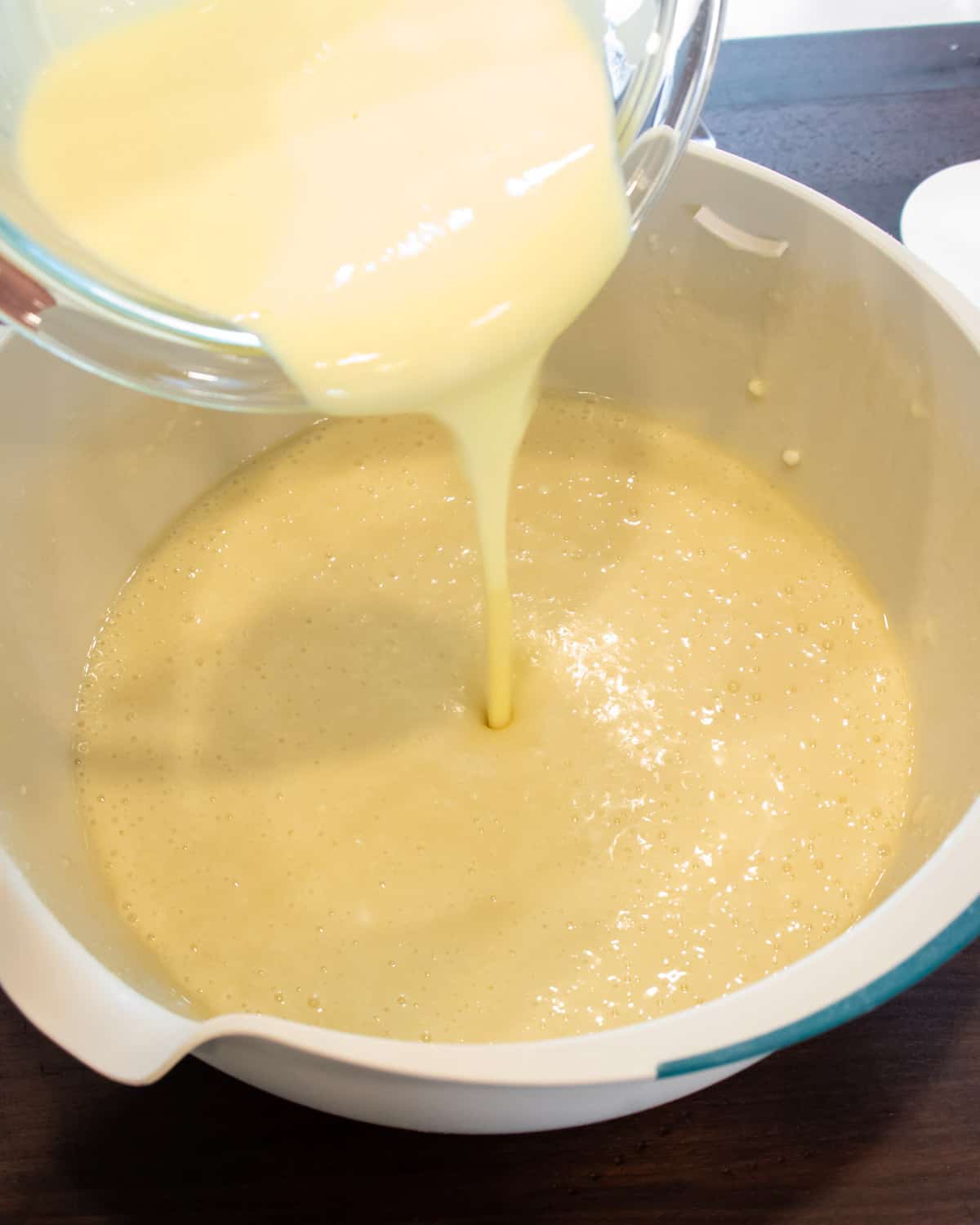 Cake batter being poured into a bowl.
