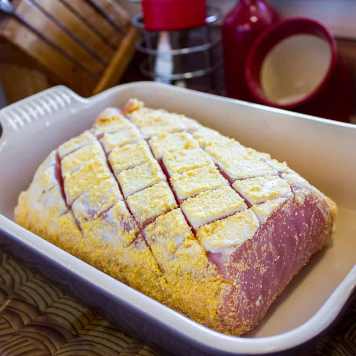 Uncooked pea meal bacon in a baking dish.