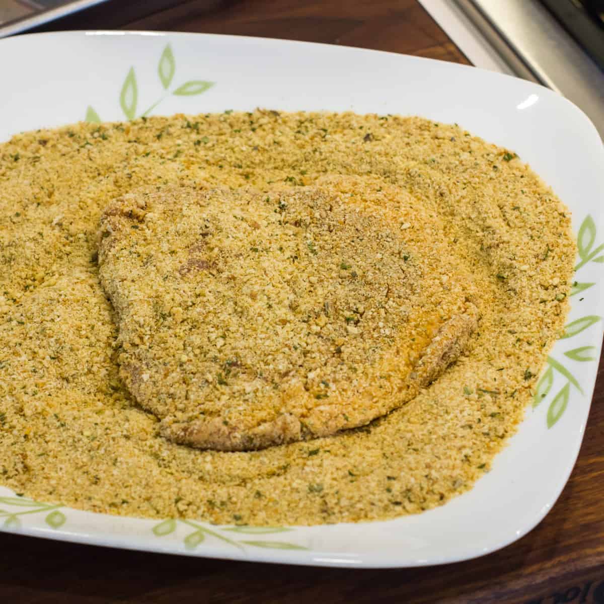 Pork cutlet dredged in bread crumbs.