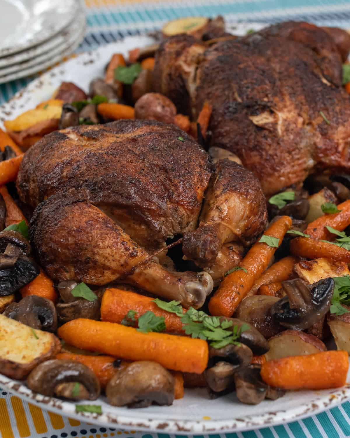 Cooked chicken with roasted potatoes, carrots and mushrooms.