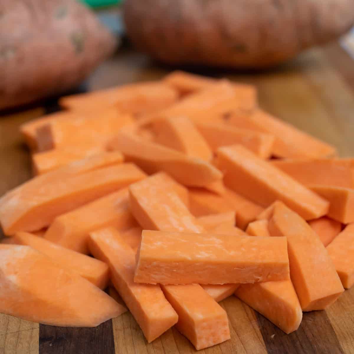 A close up pic of raw sweet potato fries.