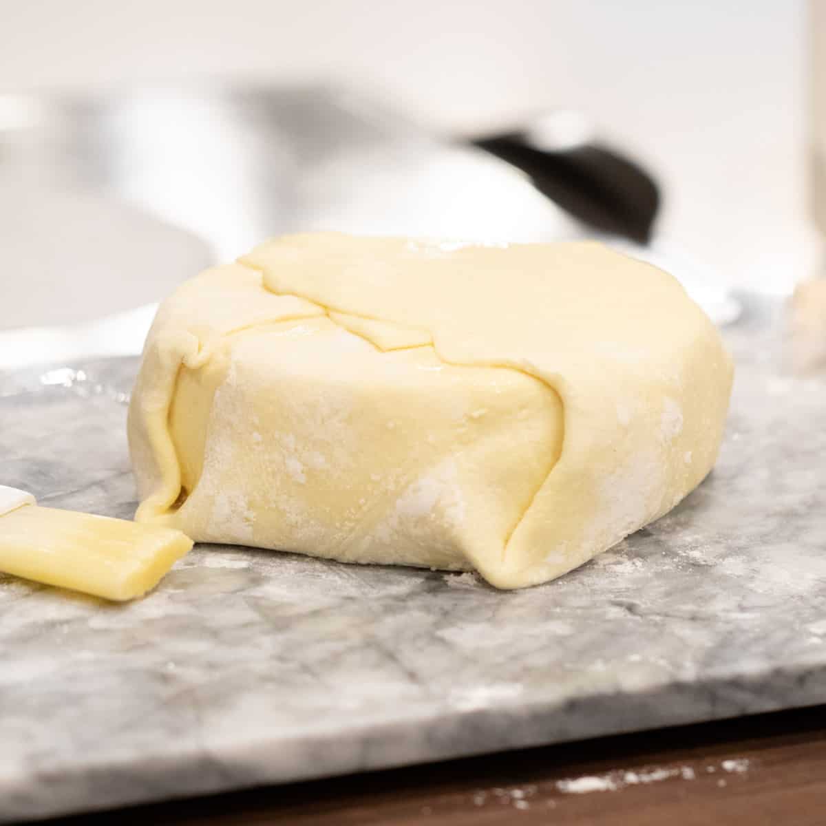 Puff pastry folded over a wheel of cheese.