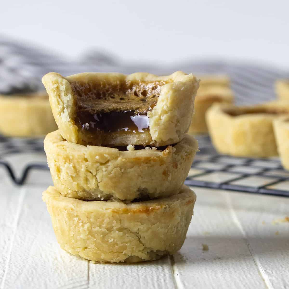 Three butter tarts in a stack.