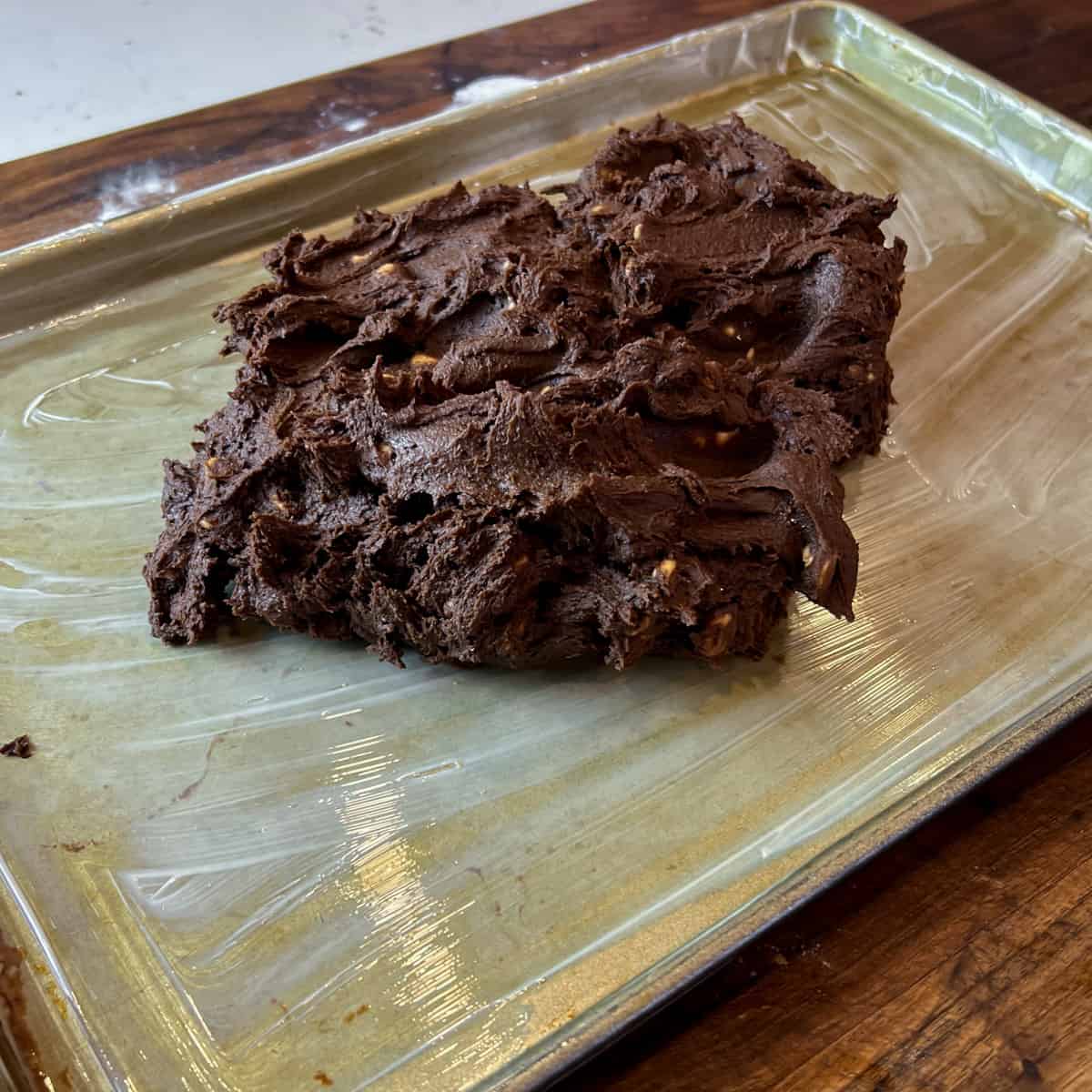 Spreading cookie dough on a baking sheet.