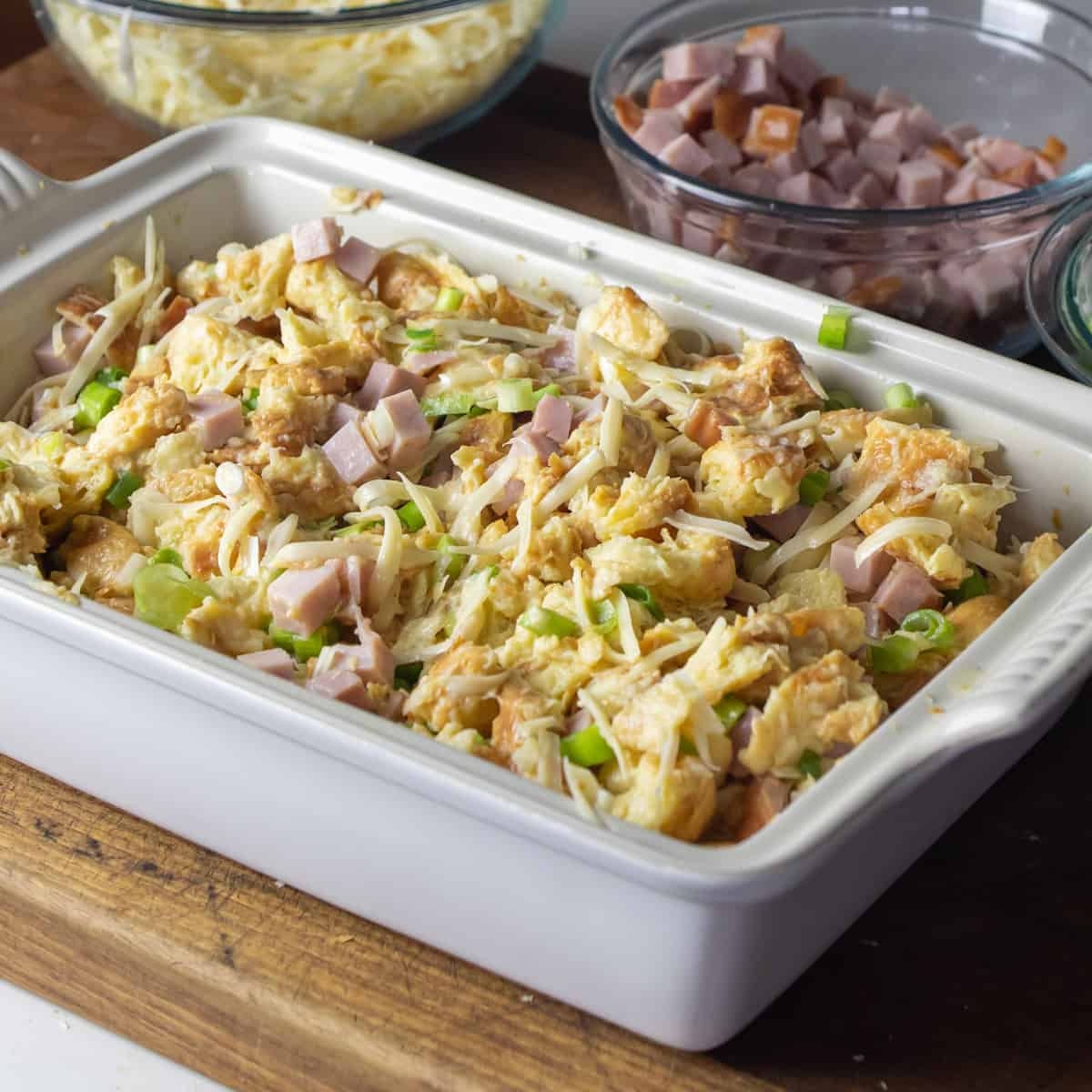 Breakfast casserole in a baking dish ready to go in the oven.