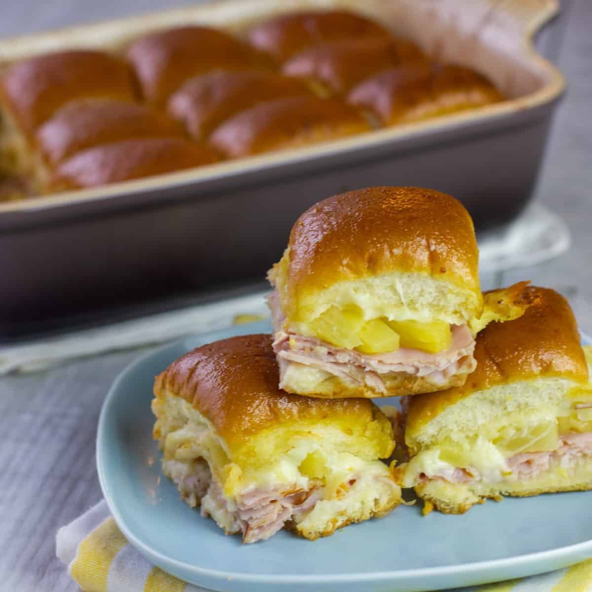 A stack of sliders on a plate.