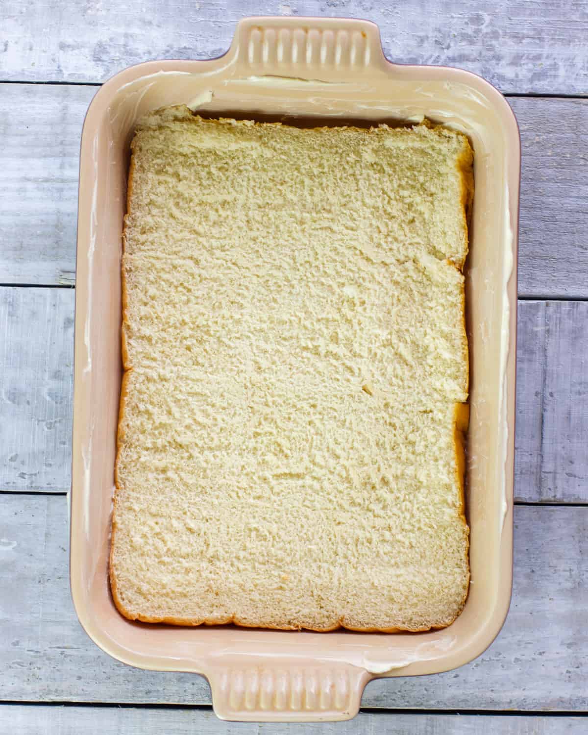 Bottom of slider buns in a baking dish.