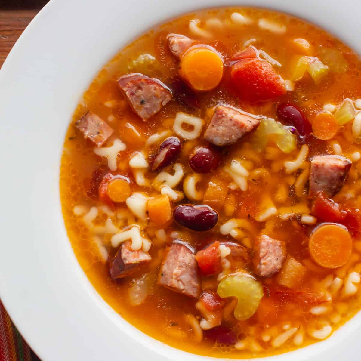 Soup with smoked sausage, carrots and pasta.