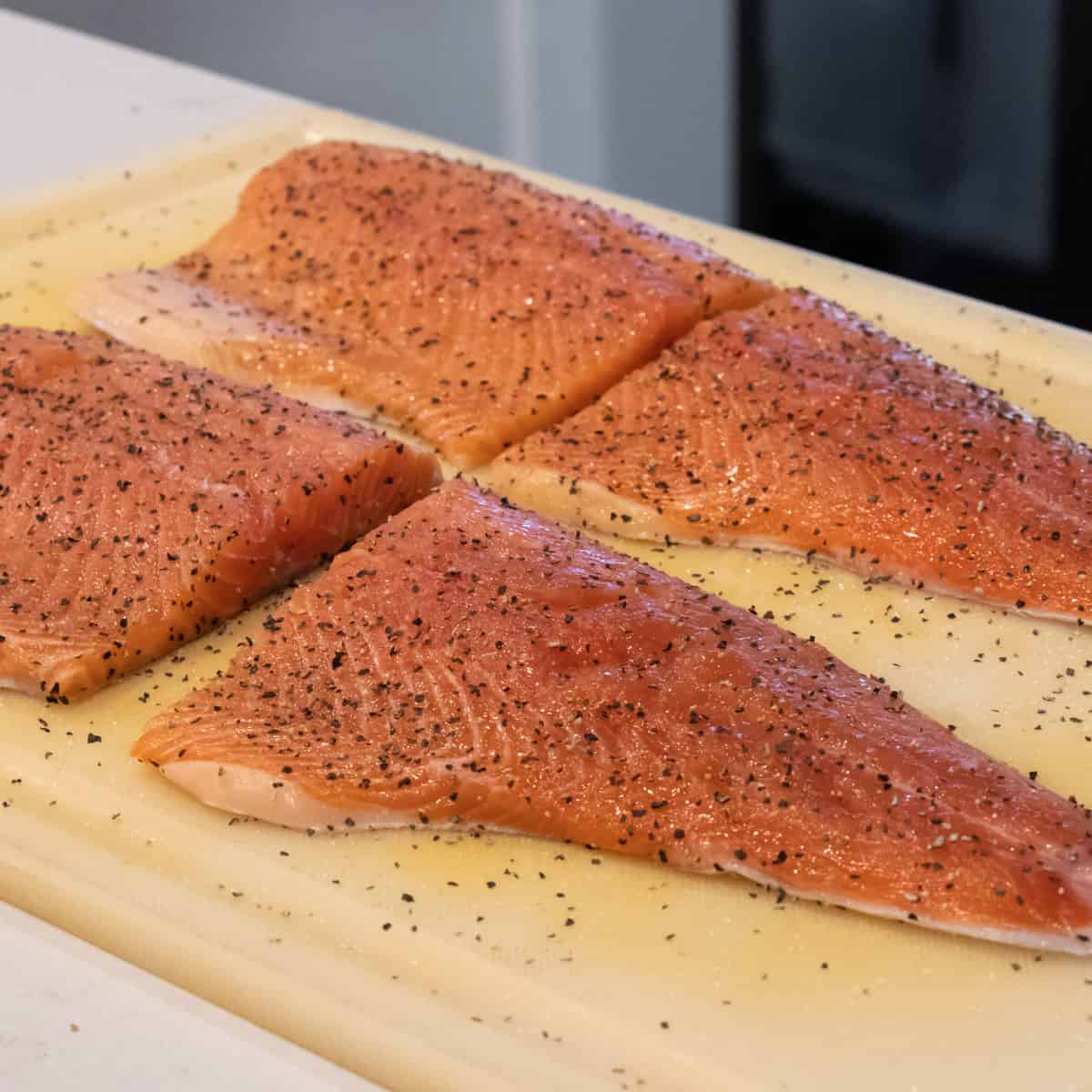 Two fillets of rainbow trout with salt and pepper.
