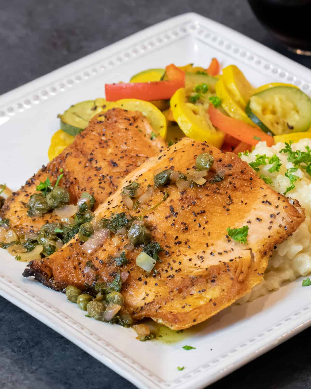 Overhead picture of a plate with fish, rice and vegetables.