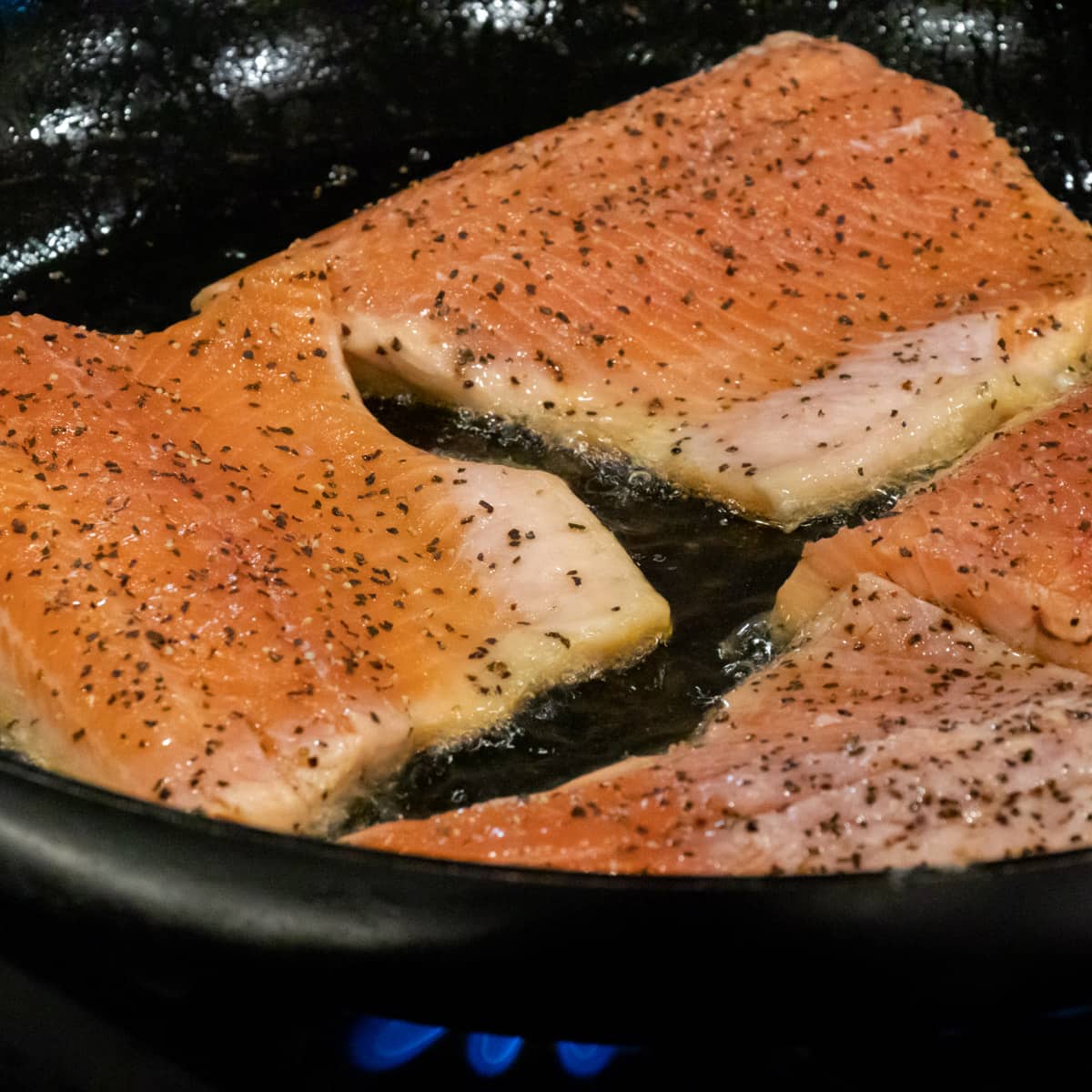 Raw fish in a skillet.