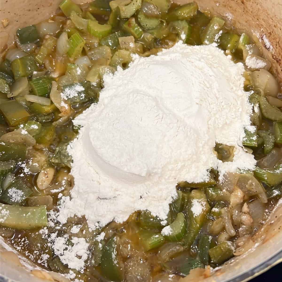 Flour on top of cooked vegetables.