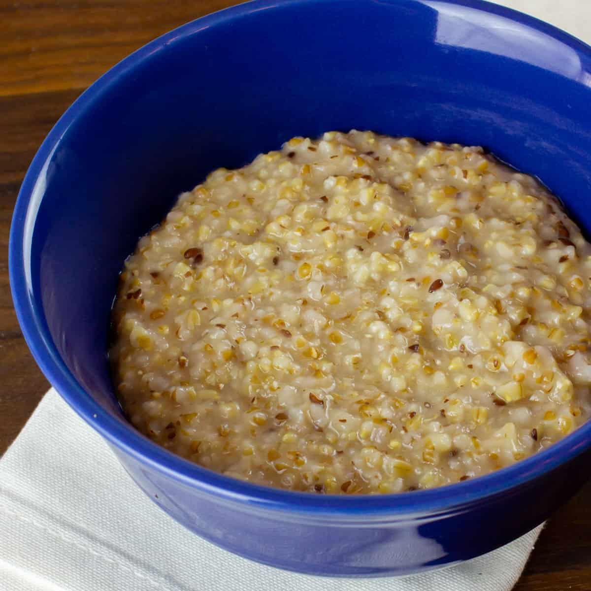 A cereal bowl filled with cooked oatmeal.
