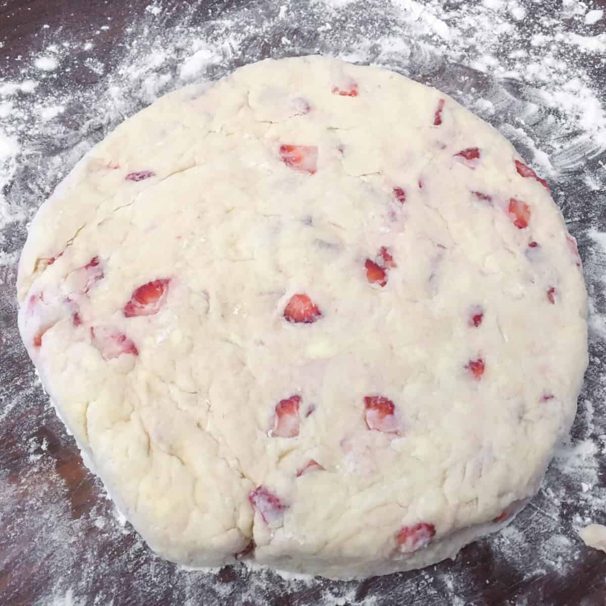 Scone dough shaped into a circle on the cutting board.