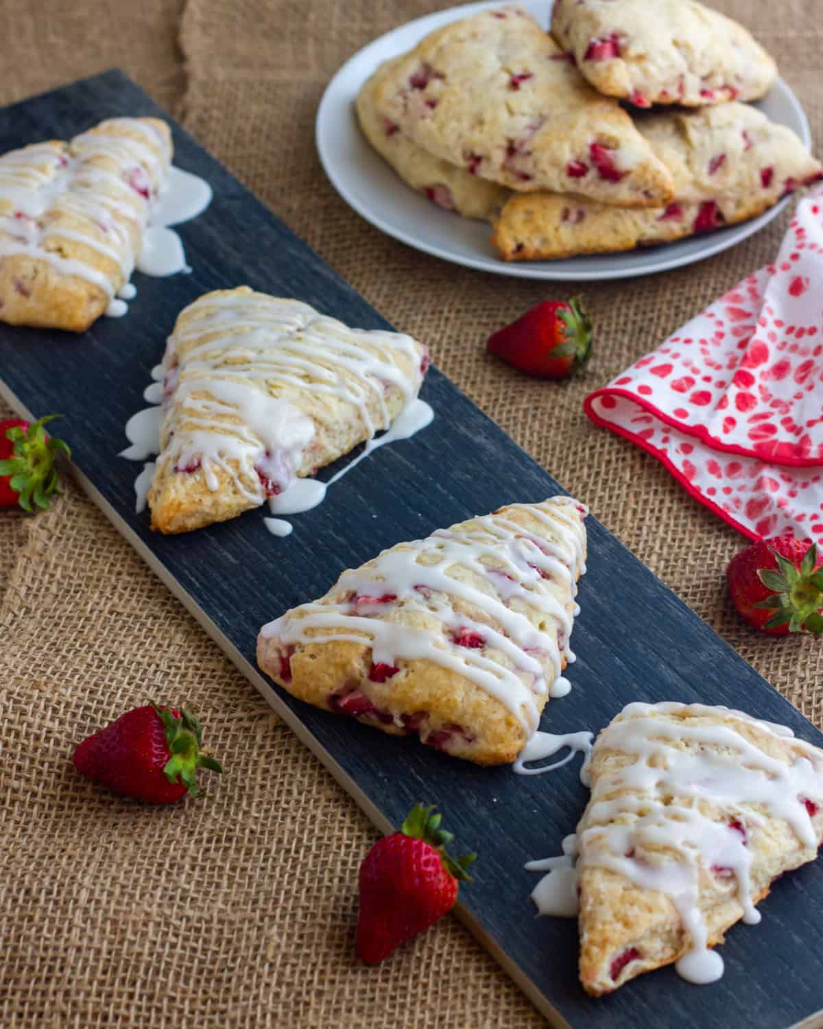 Scones on a tray with drizzled icing.