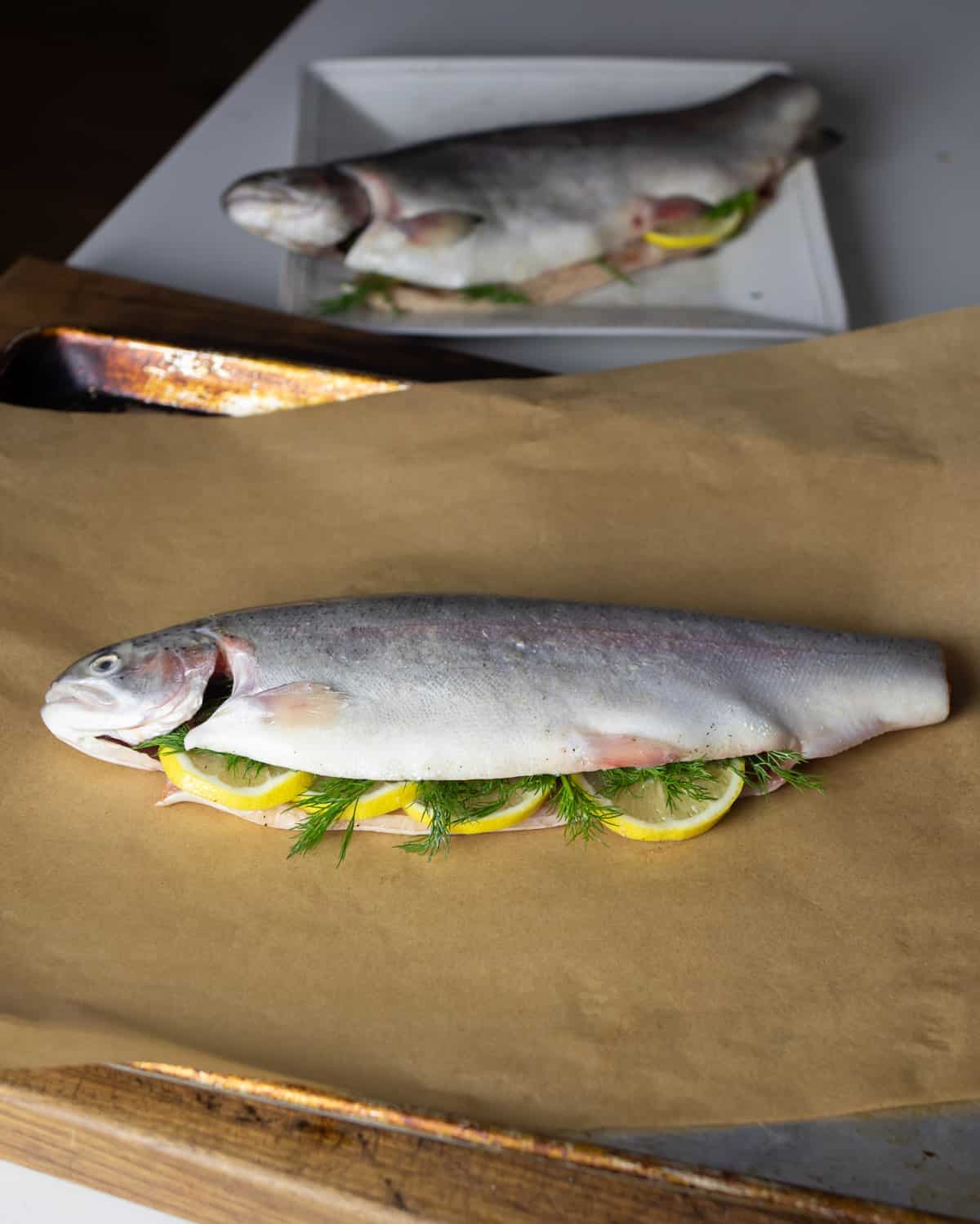 A prepared fish on a sheet of parchment paper.