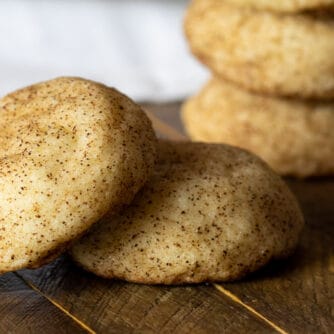 A stack of cookies on a wooden board.