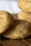 A stack of cookies on a wooden board.