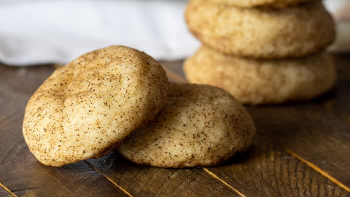 A stack of cookies on a wooden board.