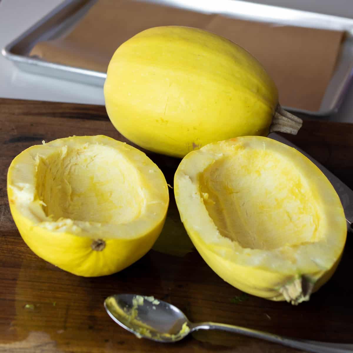 Hollowed out squash on a cutting board.