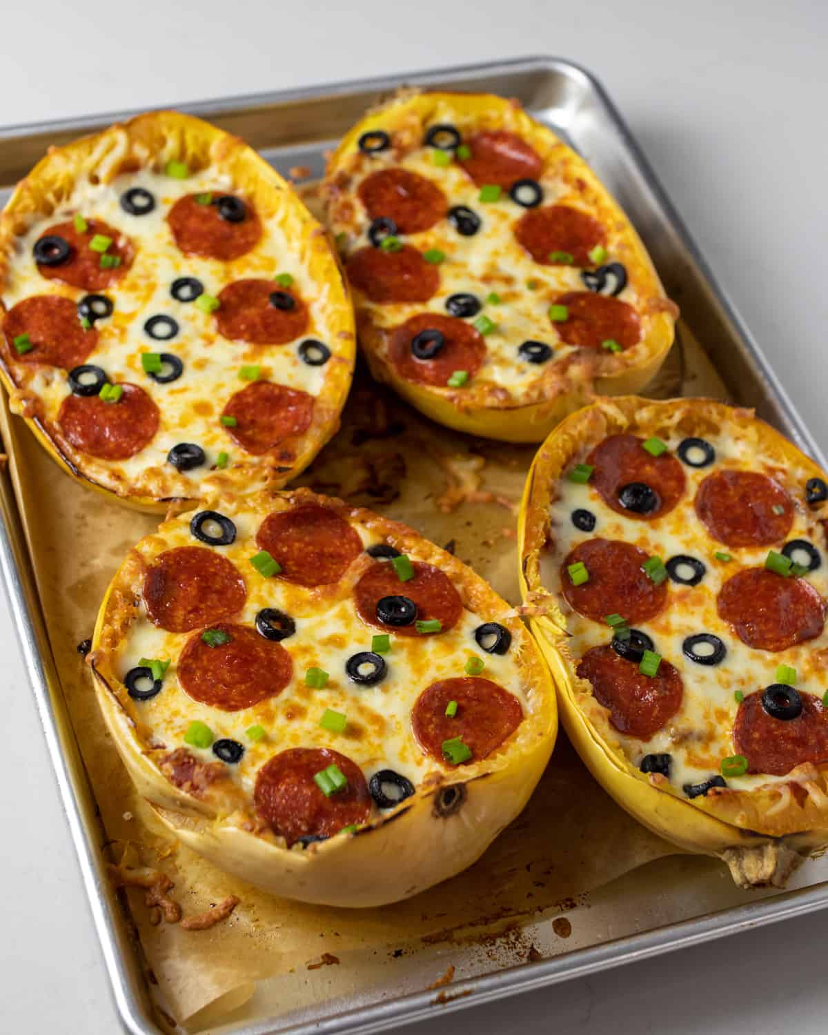 Overhead picture of baked squash with melted cheese and pepperoni.