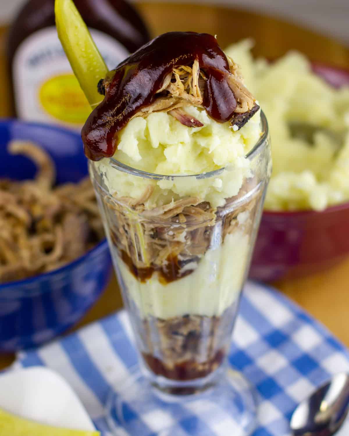 BBQ sauce drizzled on top of a pulled pork parfait.