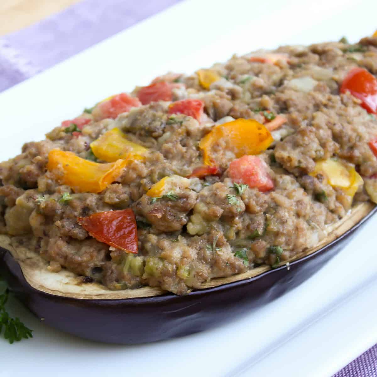 Close up picture of eggplant with a filling of meat and peppers.