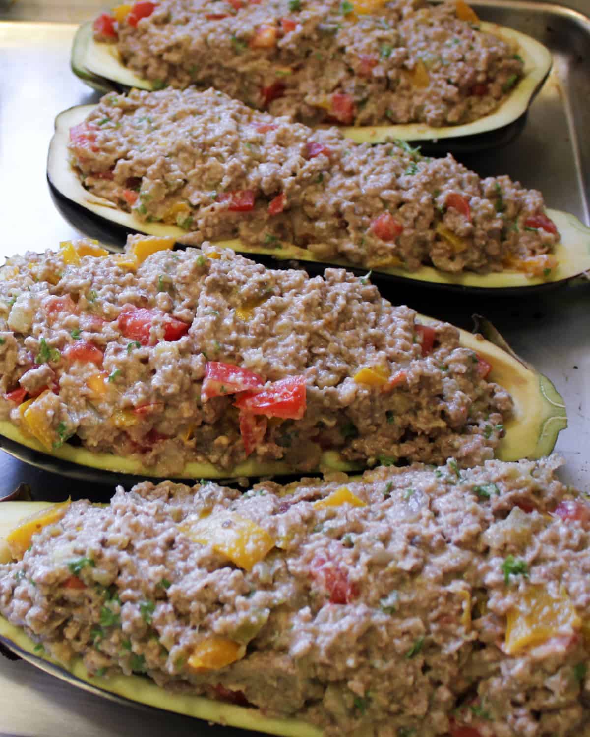 Eggplants with meat filling and ready to go in the oven.