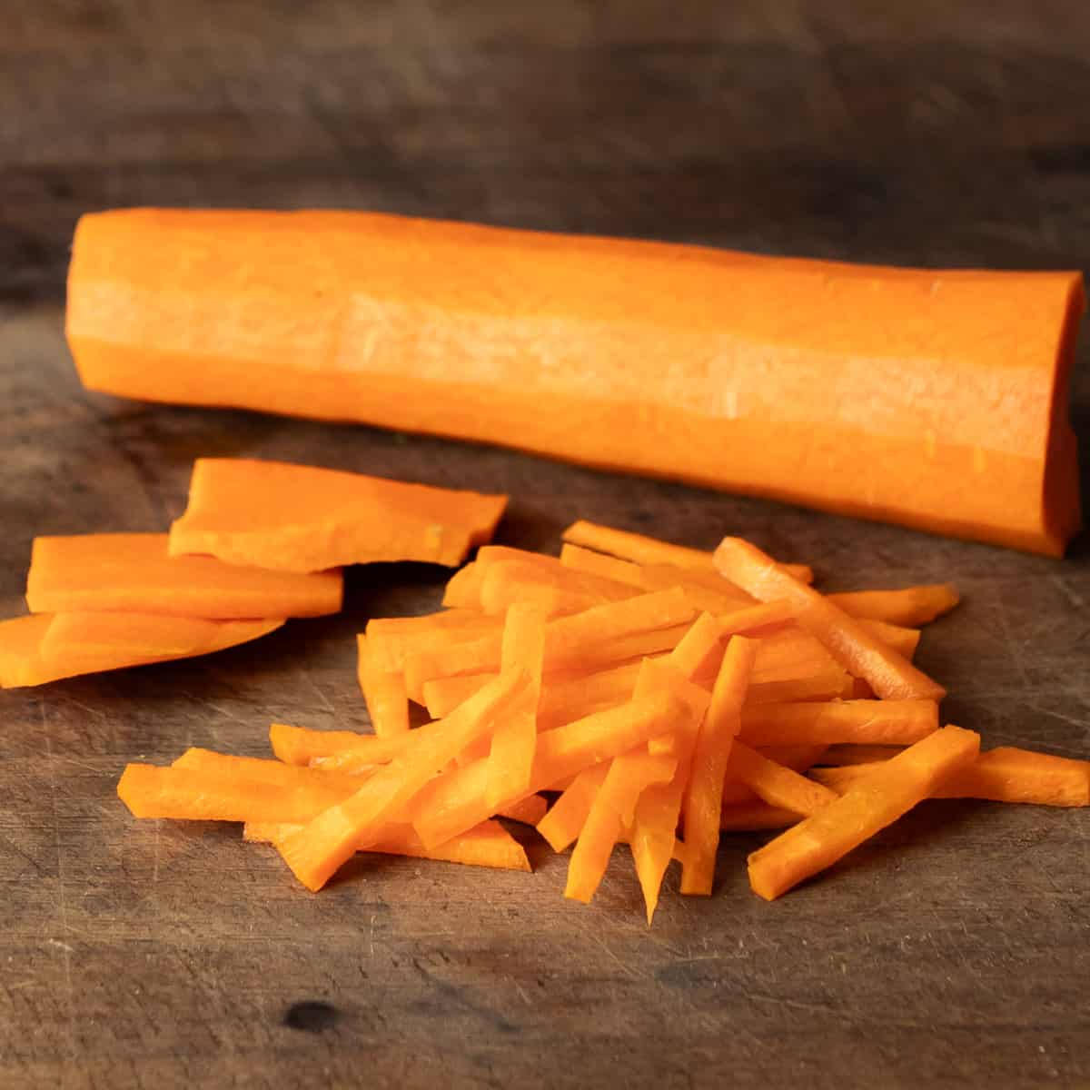 Peeled carrot sliced in a thin julienne sticks.