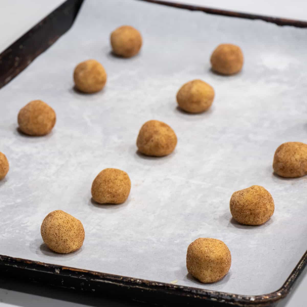 Cookie dough balls on a cookie sheet.