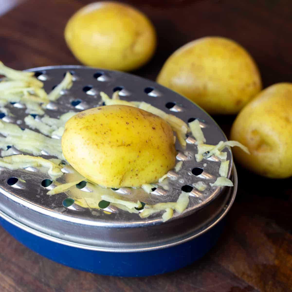 Yellow Yukon gold potatoes being grated.
