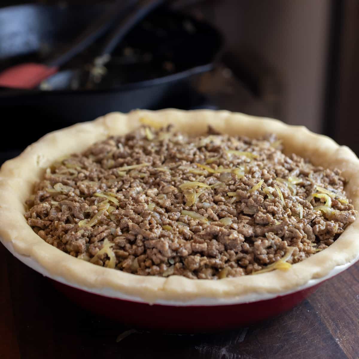 Meat filling in a pie shell.