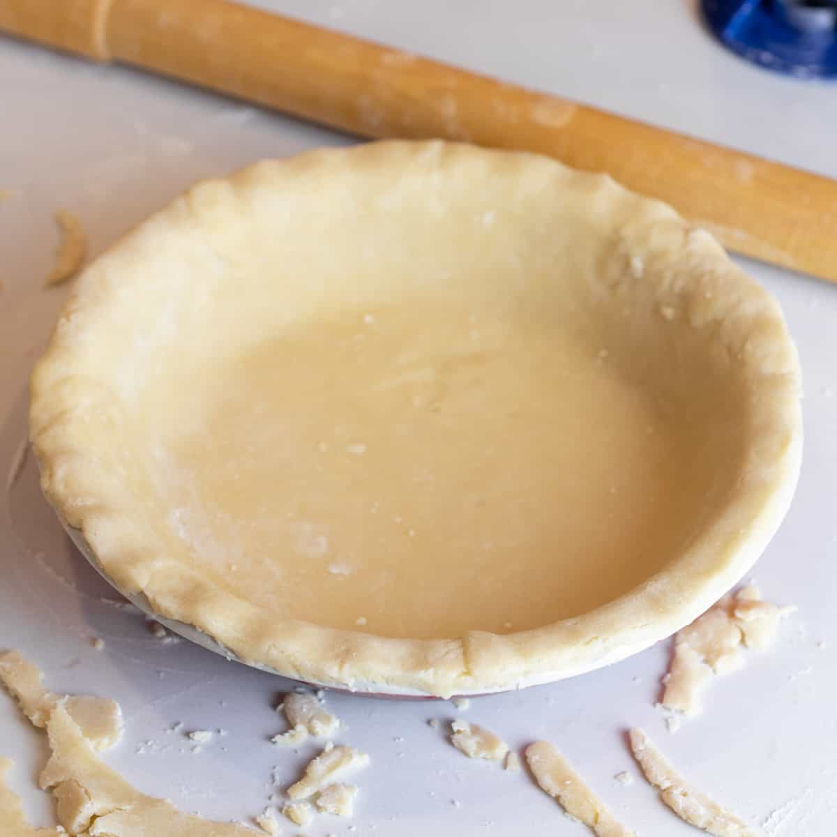 Rolled pie crust in a dish.