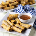 deep fried spring rolls on a plate.