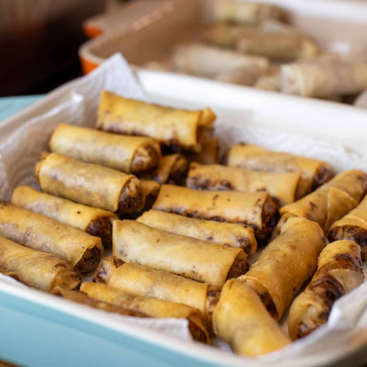 Fried spring rolls in a baking dish.