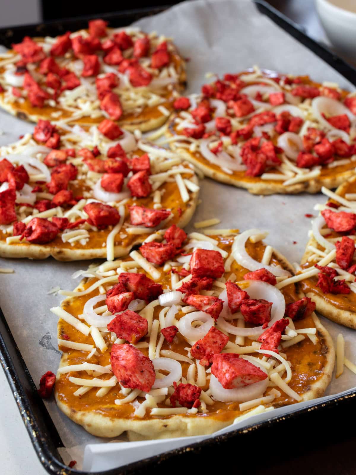 Tandoori chicken spread on top of flat bread.