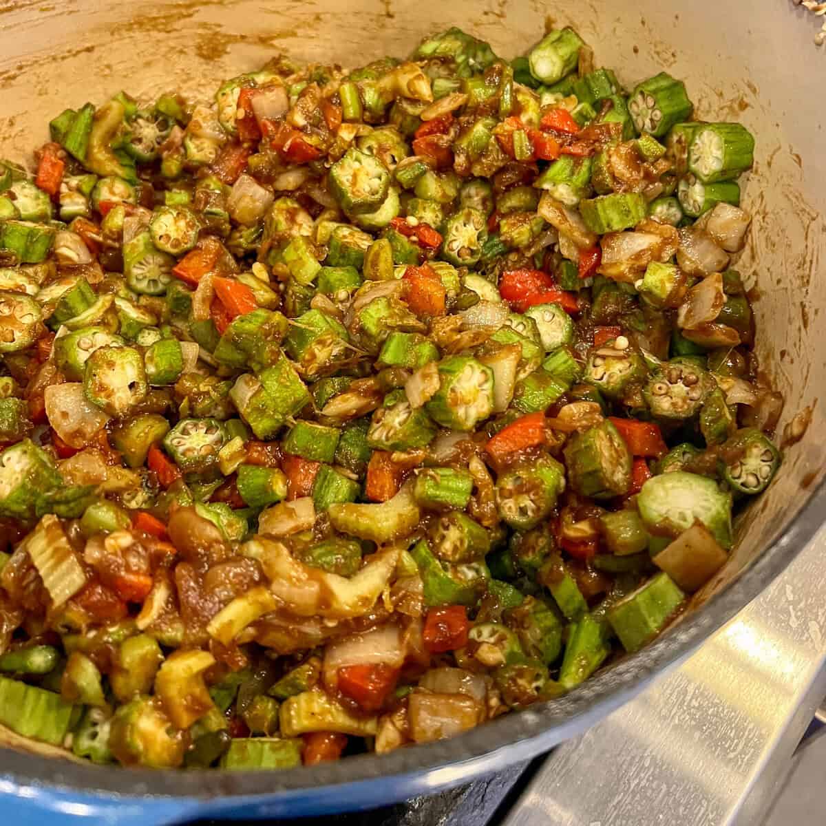 Sliced okra and other vegetables in a pot.