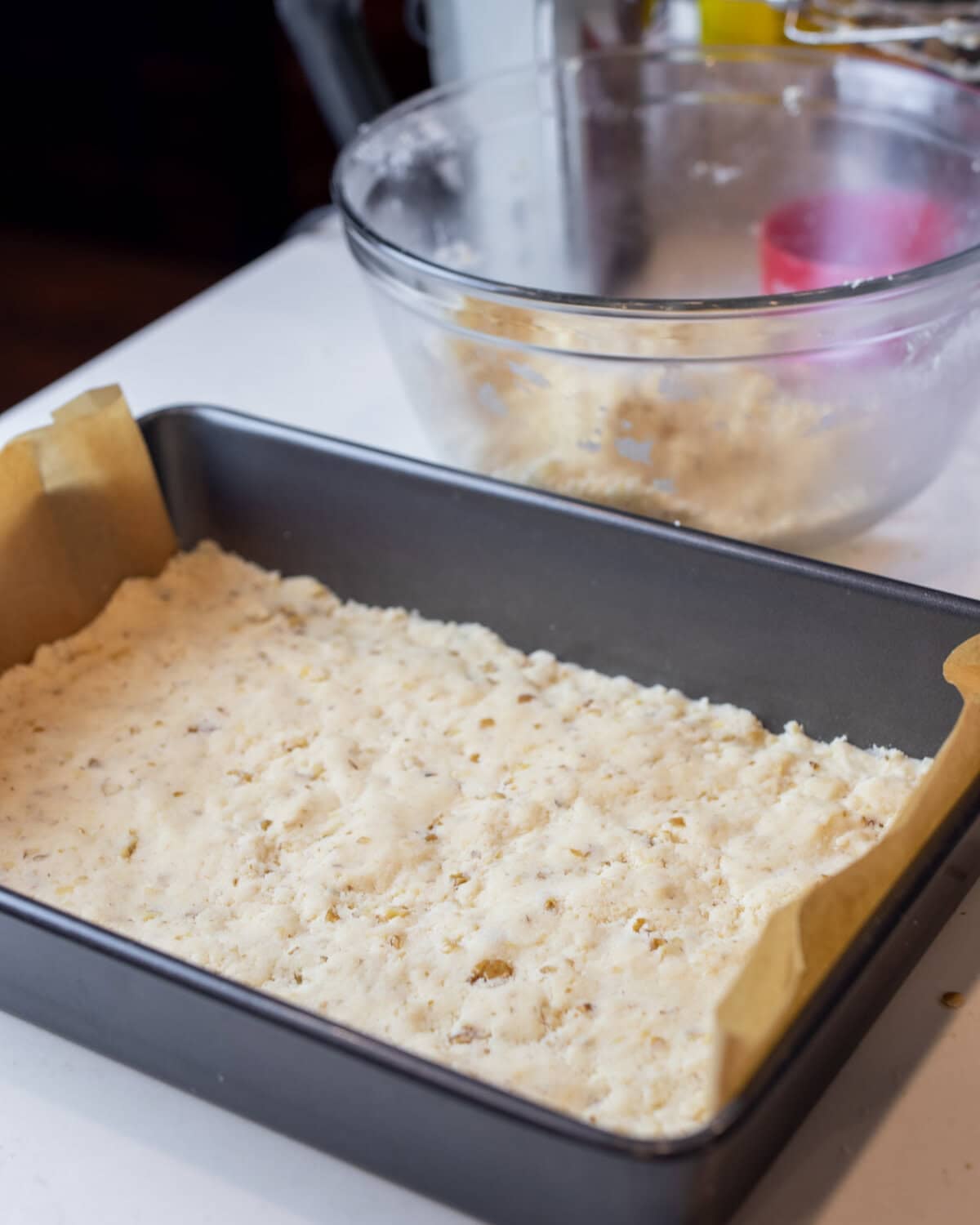 Cookie dough pressed into a baking pan.