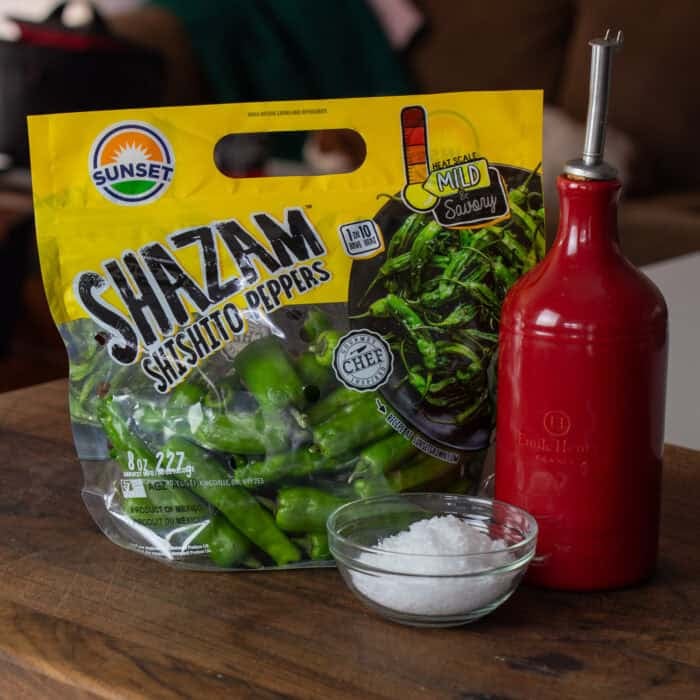 shishito peppers on a cutting board with salt